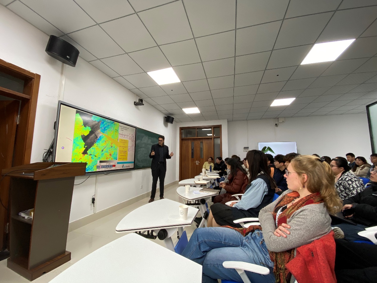 A person standing in front of a classroomDescription automatically generated